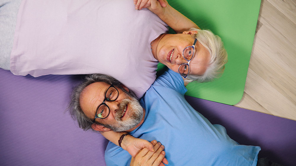 12Oaks-Elderly couple making yoga-pexels-The Benefits of Laughter Yoga for Seniors-Feature