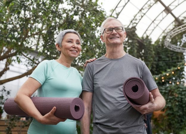 12Oaks-Man and woman holding yoga mat-canva-4 Maintains a Good Attitude