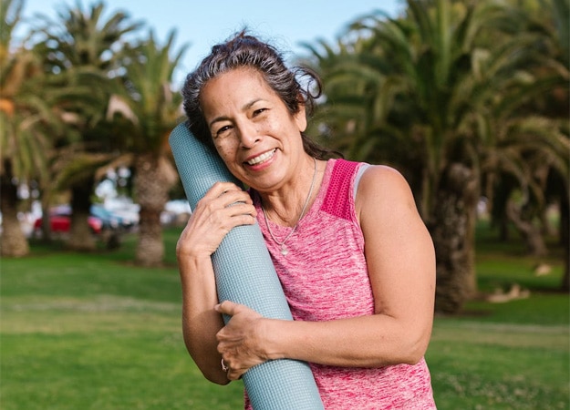 12Oaks-Senior woman holding yoga mat-pexels-1 Relieves Stress
