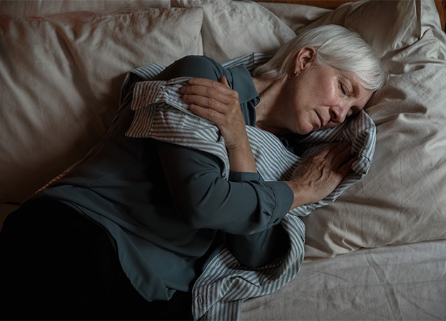 12Oaks-elderly-woman-sleeping-in-her-bed-6-Enhances-Sleep