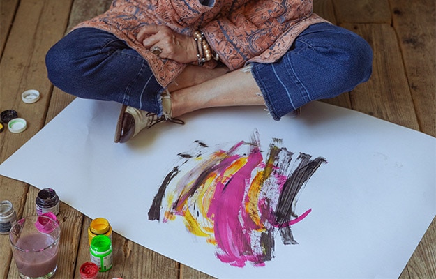 Photo-Of-Woman-Sitting-On-Floor-While-Painting---Fun-Creative-Arts-Activities-and-Ideas-for-Seniors---px-body