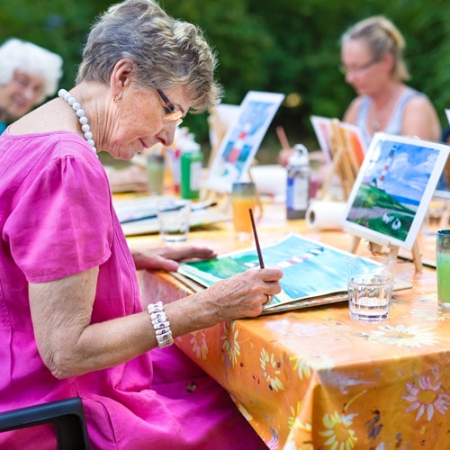 senior ladies painting outdoors