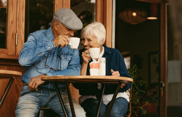 Senior-couple-relaxing-at-cafe-and-having-coffee----The-Benefits-of-Getting-Away-for-Seniors---as_body