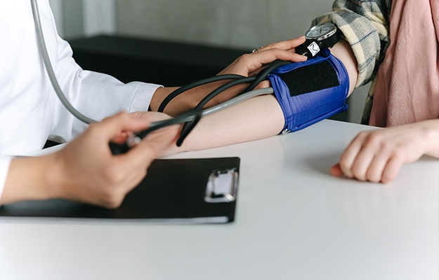 a-healthcare-worker-measuring-a-patient-s-blood-pressure-using-a-sphygmomanometer-Supports-Cardiovascular-Health