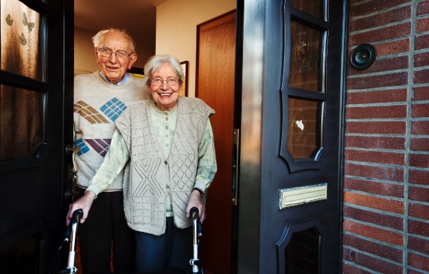 elderly-couple-opening-the-front-door---6-Must-Have-Home-Modifications-for-Aging-in-Place---as_body