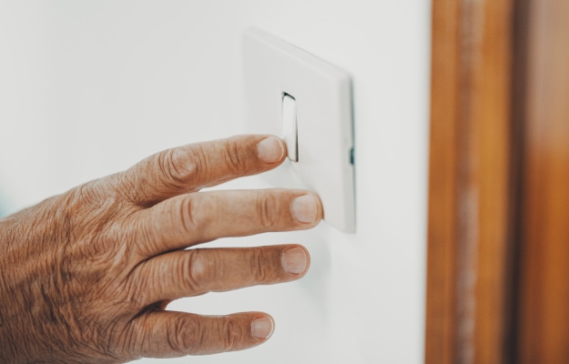senior-hand-turning-the-light-with-a-wall-switch---Change-Light-Switches---as_body
