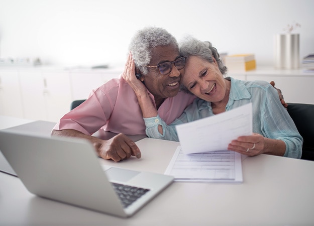 12Oaks-A happy elderly couple holding financial document-pxls-5 Set Up A Trust