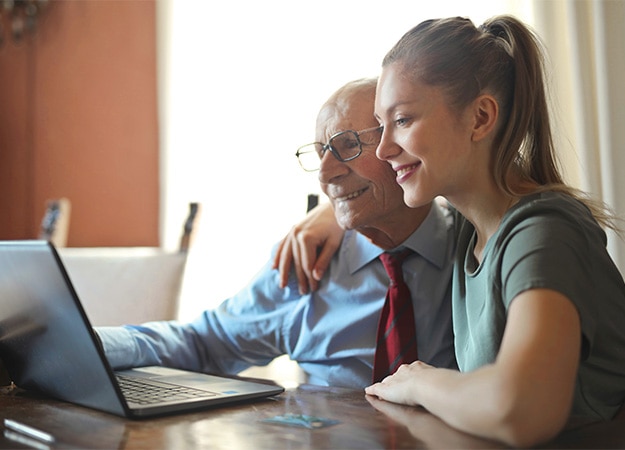 12Oaks-Adult daughter helping her elderly father with computer at home-pxls-1 Educate Your Seniors