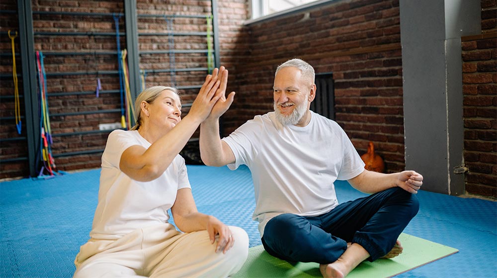 An-Elderly-Couple-High-Fiving-each-other-while-Sitting-in-the-Gym---Effective-Meditation-Techniques-For-Our-Older-Parents---px-feat