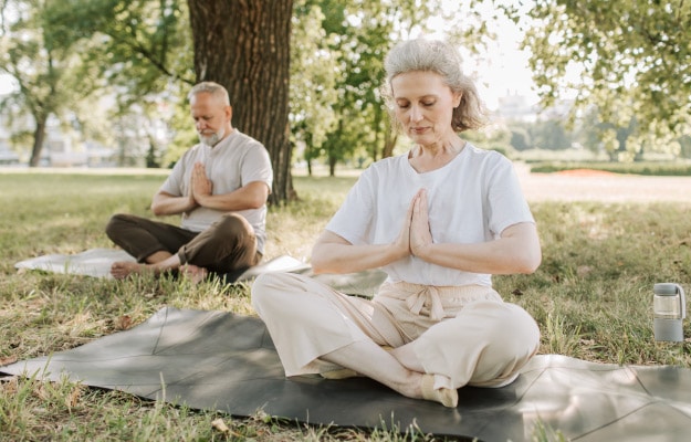 Elderly-Couple-doing-yoga-in-the-park-----relieves-Chronic-Pain_px_body