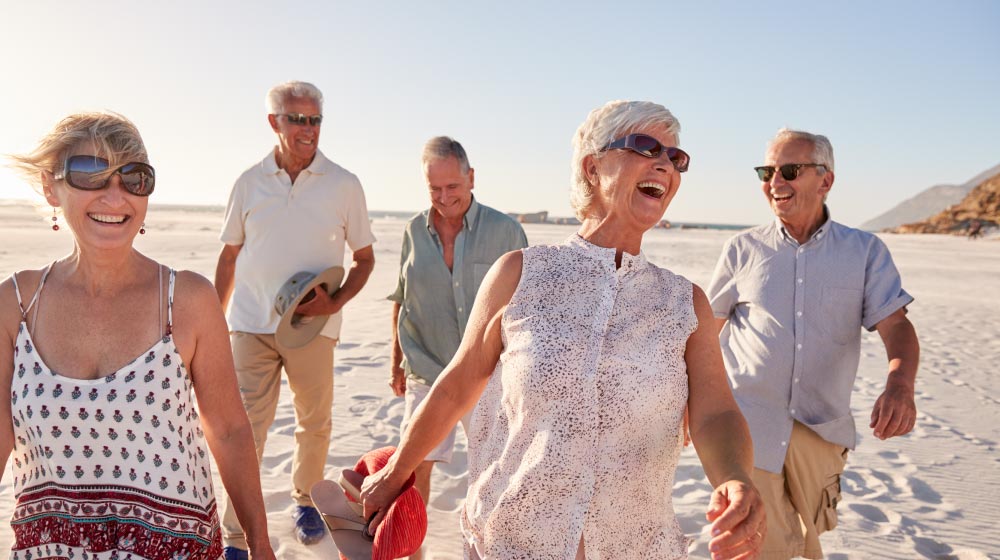 Group-Of-Senior-Friends-Walking-Along-Sandy-Beach-----Impressive-Physical-Benefits-of-Outdoor-_as_feature