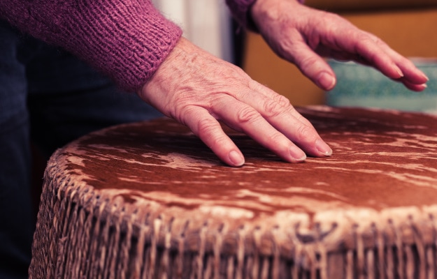 Old-woman-playing-bongo-drums-----Eases-Chronic-Pain_as_body