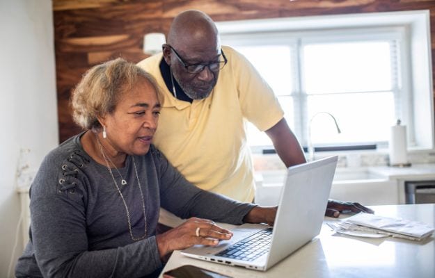 12Oaks-Elderly couple using laptop at home-cnv-3 Mastering Basic Word Processing Programs