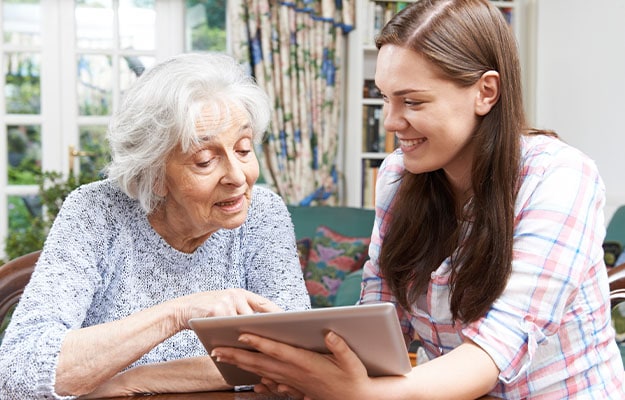 12Oaks-Teenage showing grandma how to use digital tablet-pxls-10 Navigating Social Media
