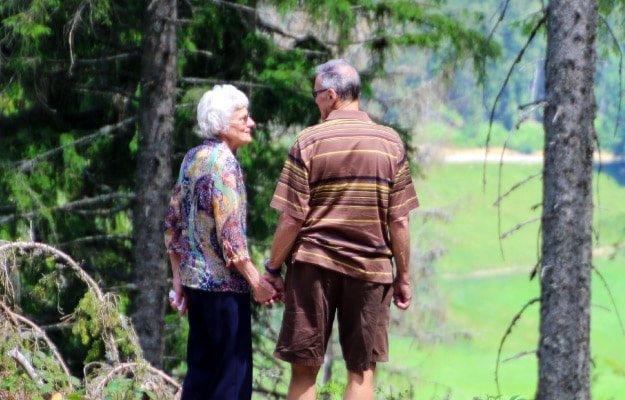 Two-seniors-Standing-in-Forest_More-Green-More-Outdoor-Spaces-at-12-Oaks-Communities