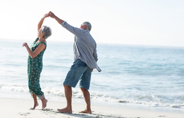 happy-senior-couple-dancing-on-the-beach-The-Benefits-of-Dance-In-Seniors-4-Enhances-Balance