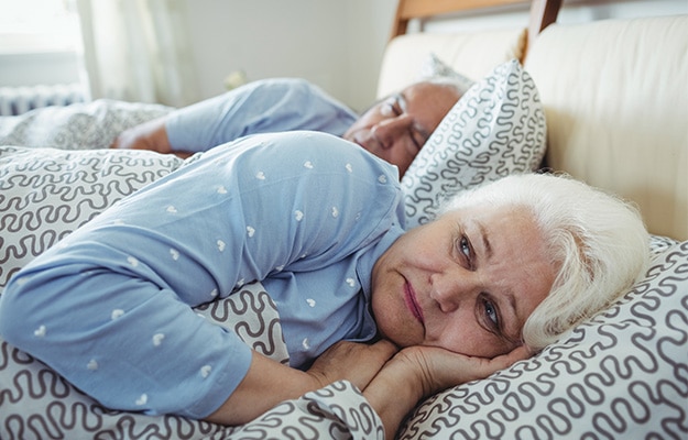 Senior-woman-awake-on-bed-Signs-and-Symptoms-of-PTSD-In-Older-Adults-px-body