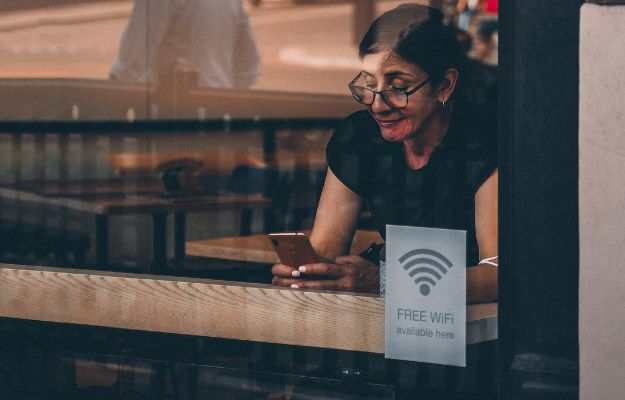12Oaks-Woman-using-free-wifi-in-cafe-pxls-4-Avoid-Accessing-Accounts-On-Public-Wi-Fi