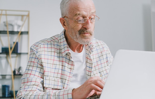 12Oaks-senior-man-using-laptop-at-home-pxls-5-Check-Accounts-Frequently