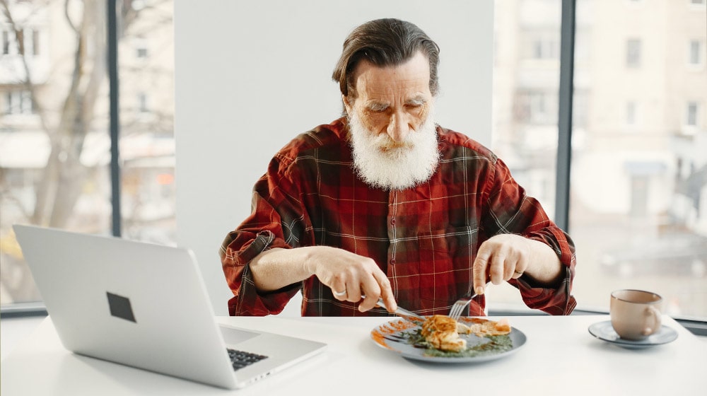 Close-Up-Shot-of-a-Man-in-Checkered-Long-Sleeve-Eating-Nutrition-Myths-Debunked-What-Seniors-Really-Need-in-Their-Diet