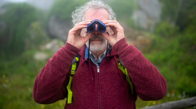 Man-in-Red-Jacket-Holding-Binoculars-The-Benefits-of-Bird-Watching-for-Older-Adults