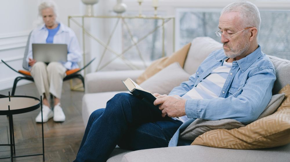 Man Reading a Book while Sitting on a Sofa featured image pexels