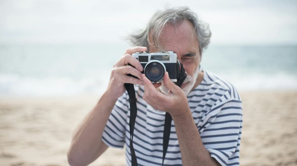 Man in the Beach Taking Picture with a Camera featured image pexels