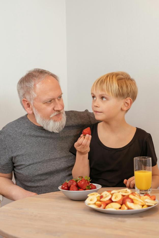 A Boy Holding a Strawberry | intermittent fasting for seniors px
