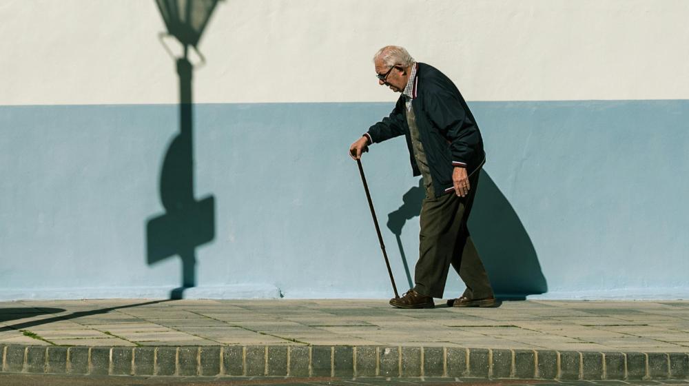 An Elderly Man Walking on the Sidewalk | benefits of walking for seniors px featured image