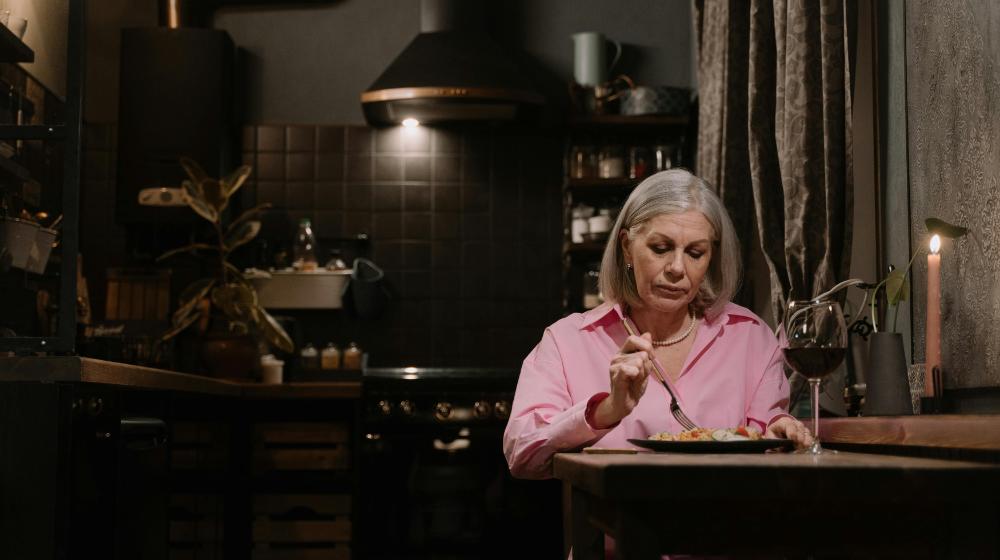 An Elderly Woman Eating Alone at Home | intermittent fasting for seniors px featured image