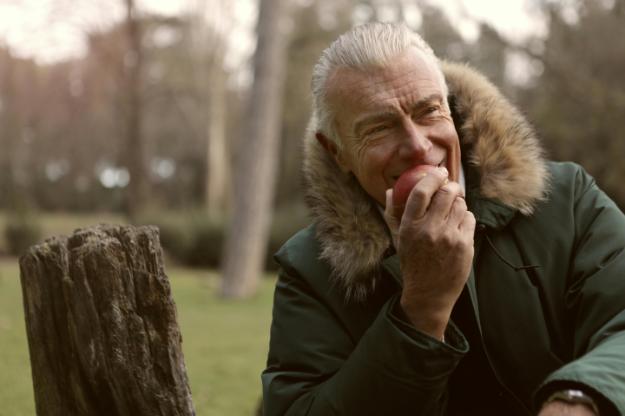 Man in Green Parka Jacket Covering His Face With His Hand | intermittent fasting for seniors px