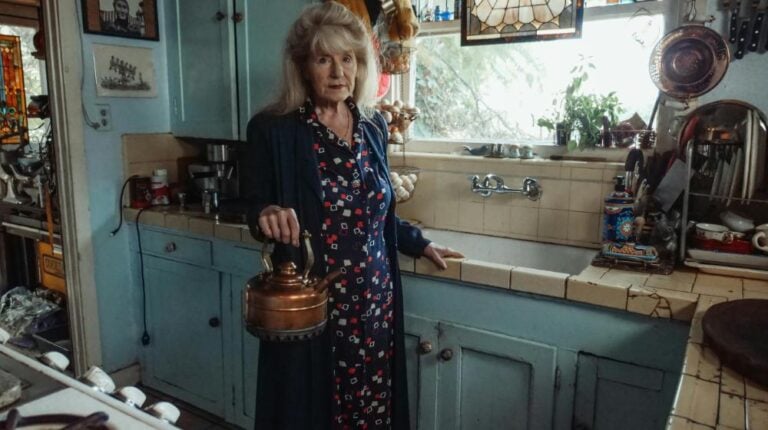 woman standing in kitchen | is dementia hereditary or genetic px featured image