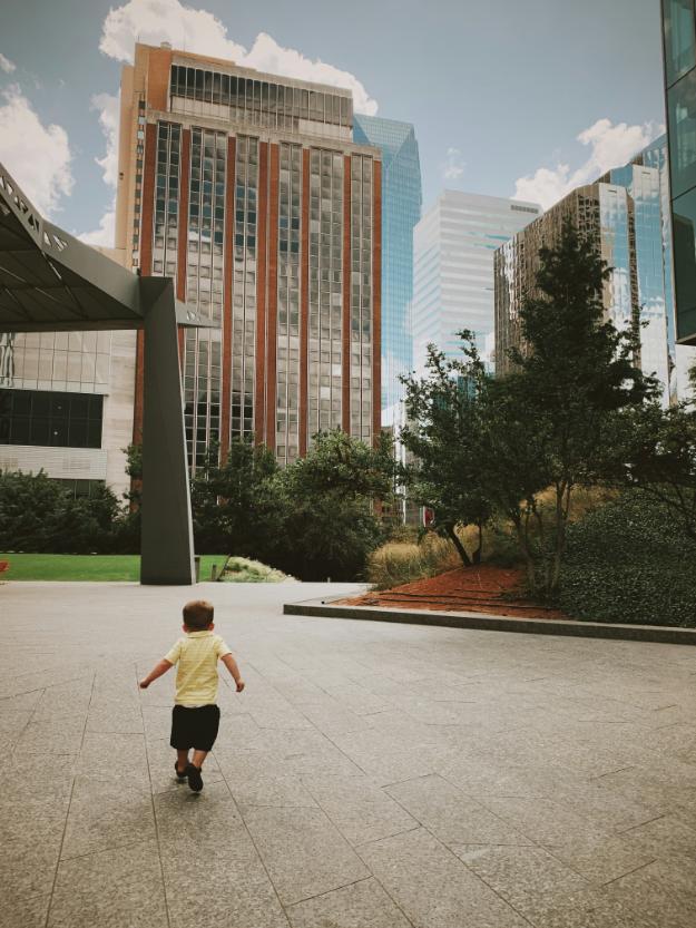 a small child is running in a courtyard fun activities in okc for adults us