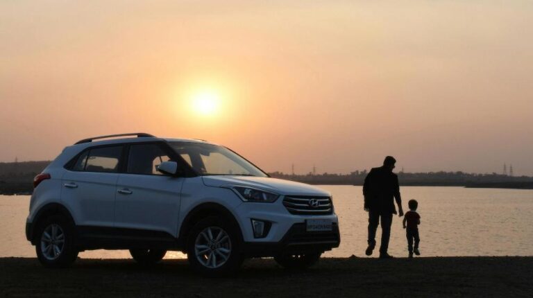 Silhouette of Man and Child Near White Hyundai Tucson Suv during Golden Hour Car Insurance for Seniors px featured image (1)