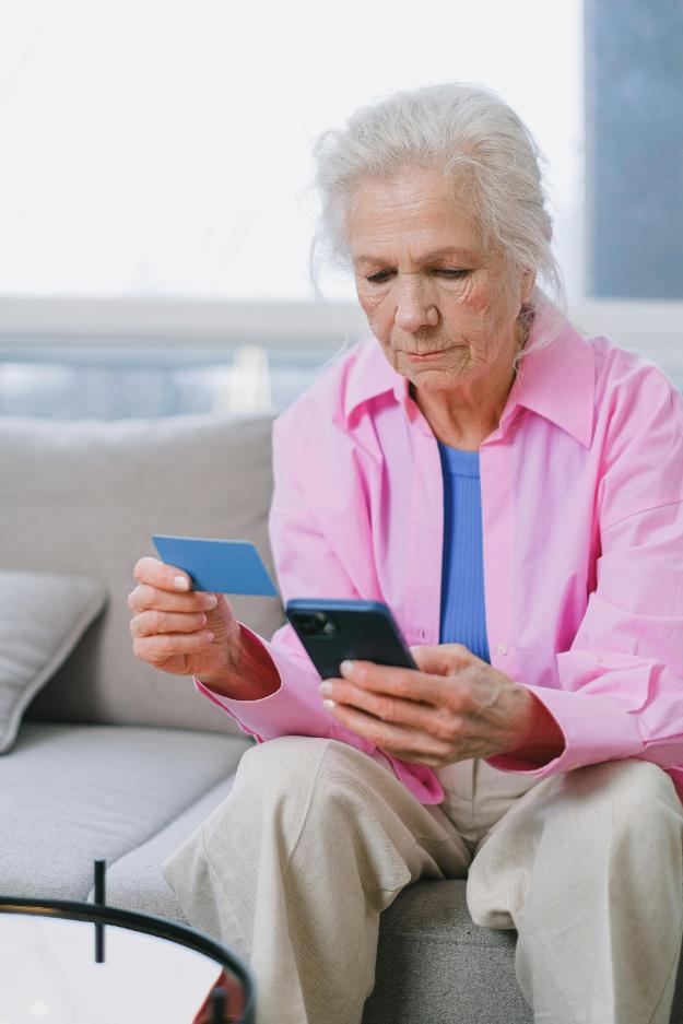 Elderly Woman using Smartphone and Card | Black Friday safety for seniors px