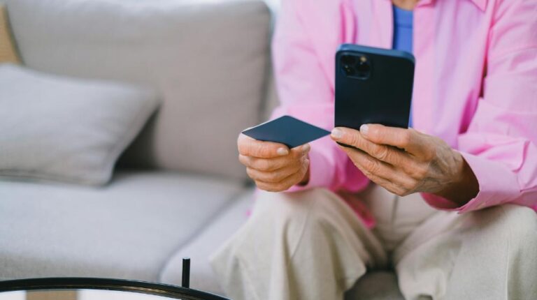 Person using Smartphone and Credit Card | Black Friday safety for seniors px featured image