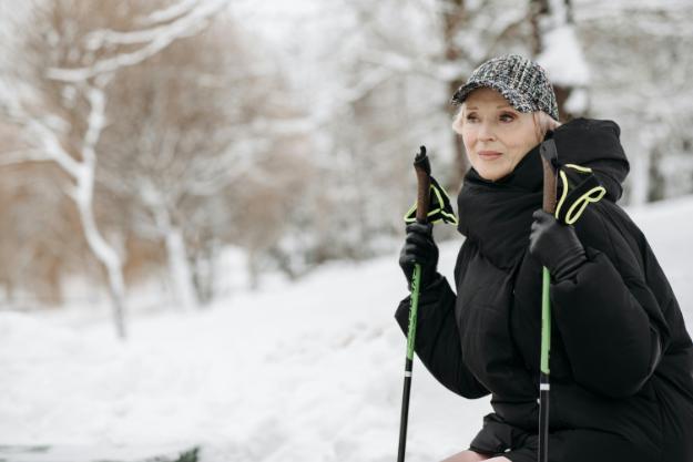 Woman Holding Trekking Poles while Sitting _ thanksgiving travel tips for seniors px