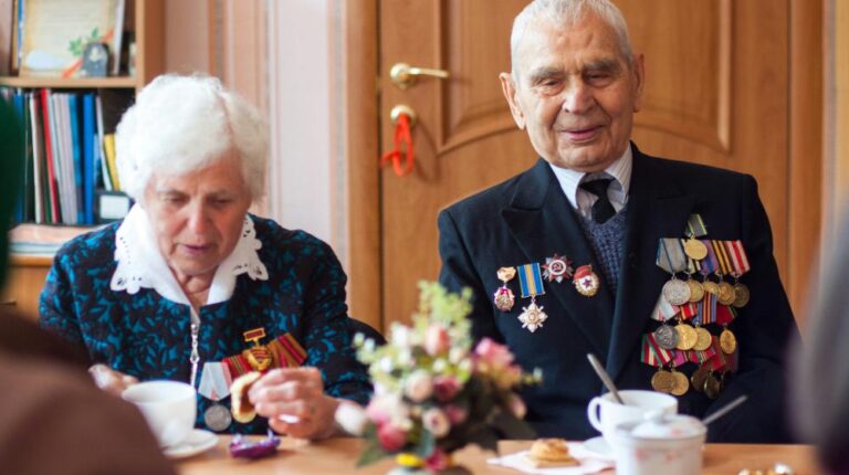 man and woman drinking coffee in front of wooden table featured image us
